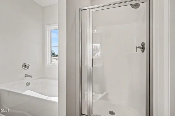 a white house with a big yard and large trees