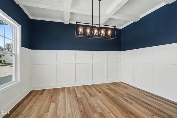 a dining room with furniture a chandelier and wooden floor