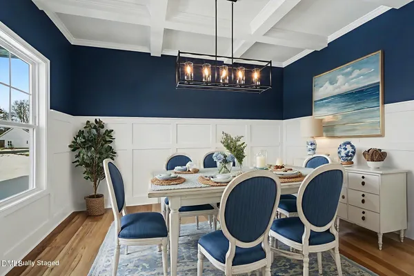 a living room with a fireplace dining table and a chandelier