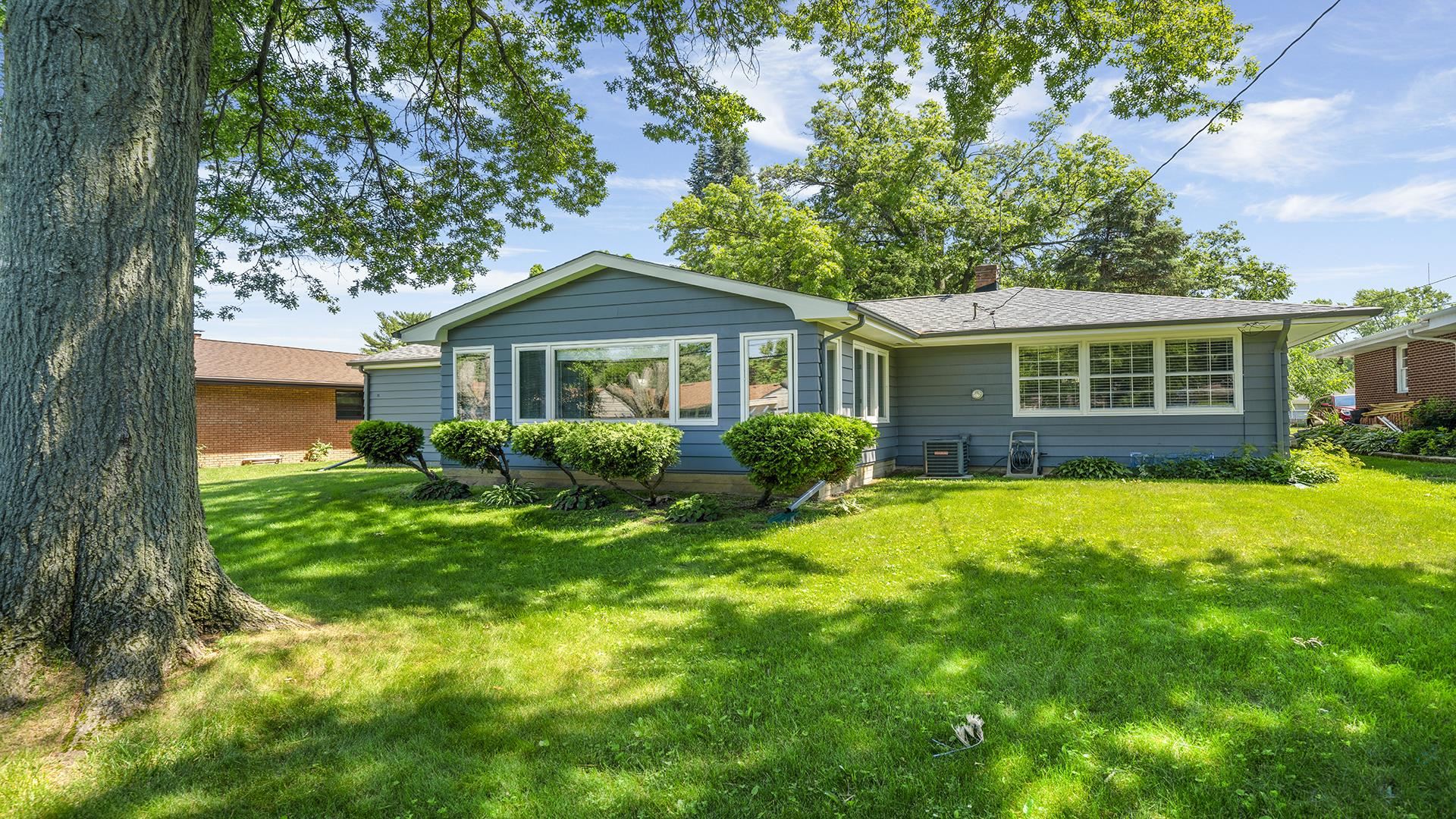3848 Highcrest Road Rockford, IL 61107 - Photo 3 of 29 a front view of a house with a yard and potted plants