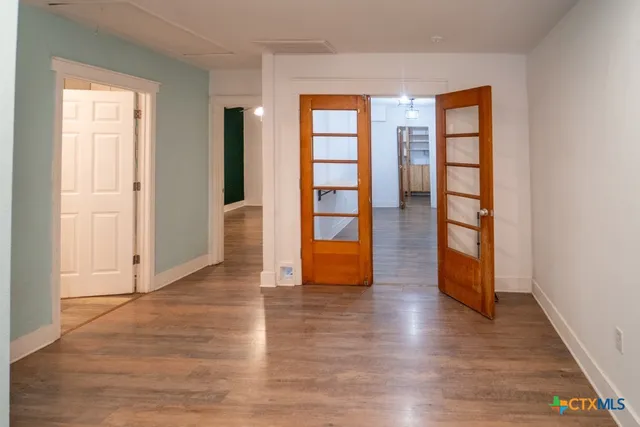 an empty room with wooden floor and closet