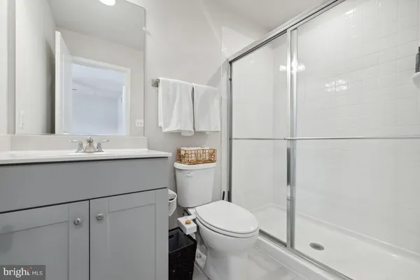 a bathroom with a sink mirror vanity and toilet