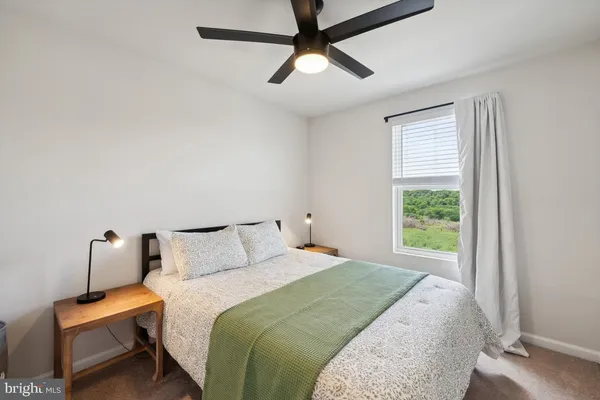 a bedroom with a bed and window