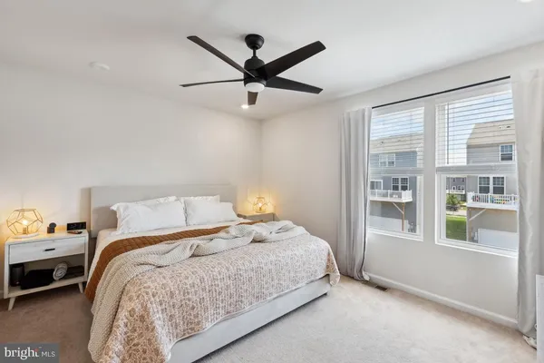 a bedroom with a bed and a large window