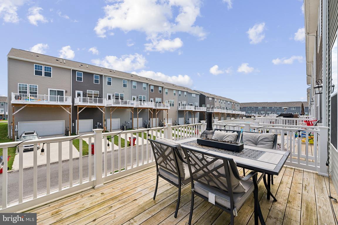 195 Presidents Pointe Avenue Ranson, WV 25438 - Photo 19 of 22 a roof deck with a table and chairs