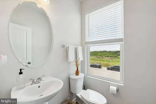 a bathroom with a sink a toilet and a mirror