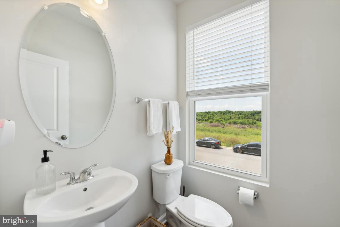 195 Presidents Pointe Avenue Ranson, WV 25438 - Photo 7 of 22 a bathroom with a sink a toilet and a mirror