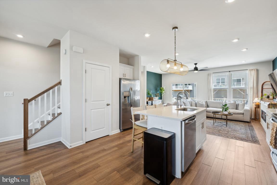 195 Presidents Pointe Avenue Ranson, WV 25438 - Photo 8 of 22 a view of a kitchen with kitchen island a stove a refrigerator a sink dishwasher with a dining table and chairs