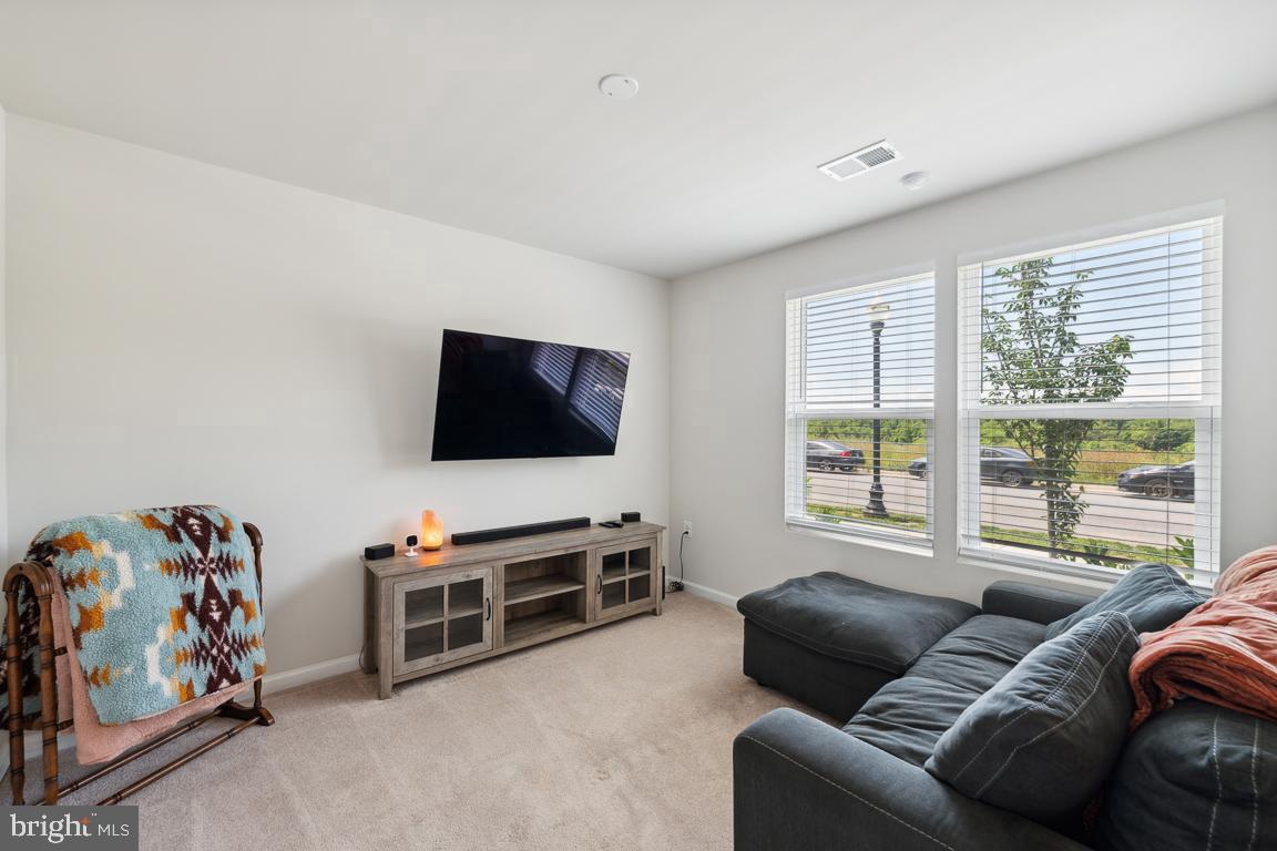 195 Presidents Pointe Avenue Ranson, WV 25438 - Photo 10 of 22 a living room with furniture and a flat screen tv