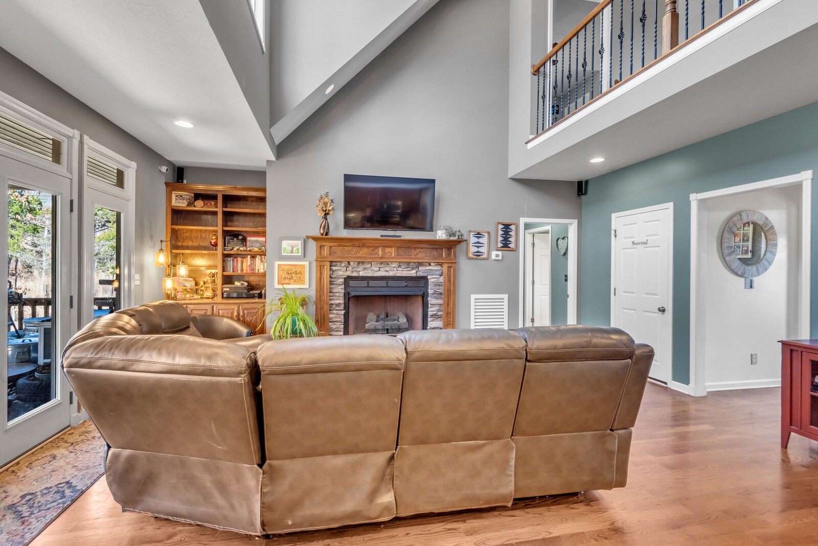 285 Heggie Road Erin, TN 37061 - Photo 12 of 50 a living room with furniture a fireplace and a flat screen tv