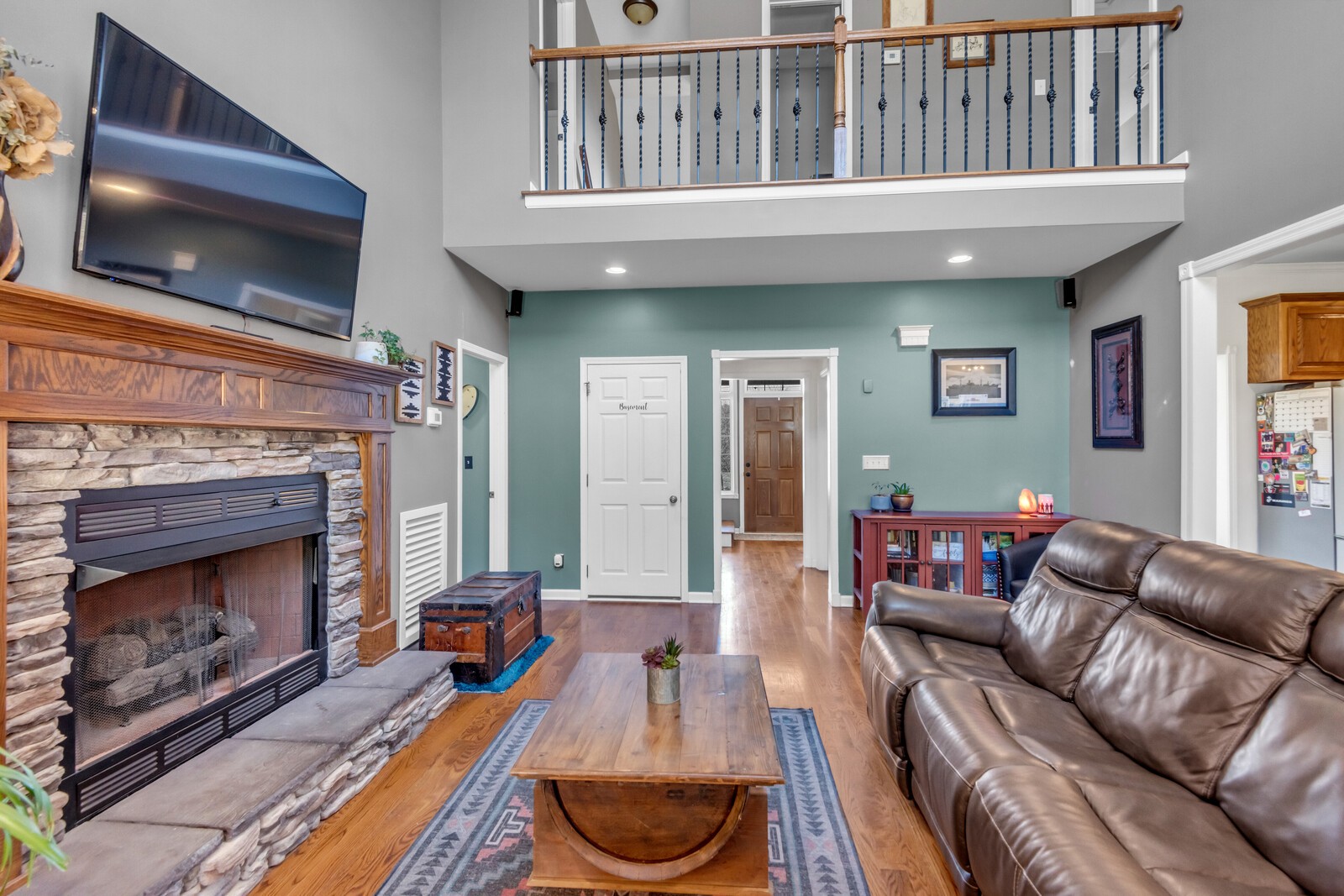 285 Heggie Road Erin, TN 37061 - Photo 13 of 50 a living room with furniture a flat screen tv and a fireplace