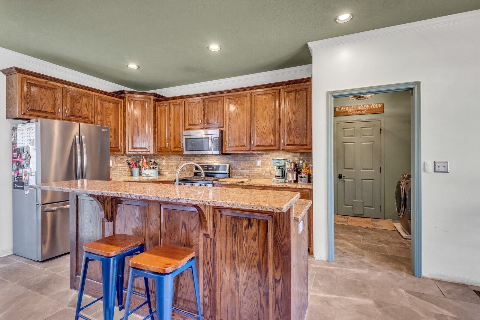 285 Heggie Road Erin, TN 37061 - Photo 15 of 50 a kitchen with stainless steel appliances granite countertop a refrigerator and a stove top oven
