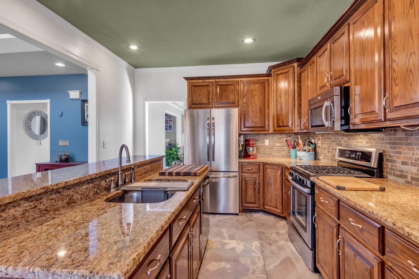 285 Heggie Road Erin, TN 37061 - Photo 16 of 50 a kitchen with stainless steel appliances granite countertop a sink stove and refrigerator