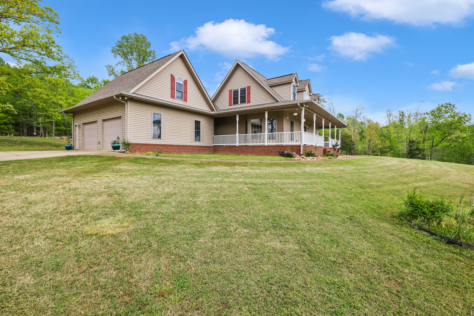 285 Heggie Road Erin, TN 37061 - Photo 2 of 50 a front view of a house with a garden