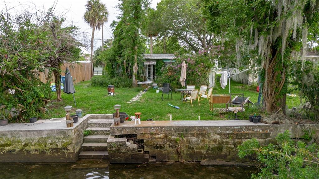 5323 Circle Drive Weeki Wachee, FL 34607 - Photo 4 of 77 a view of a house with backyard sitting area and garden