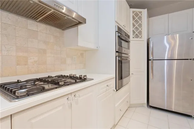 a white refrigerator freezer and a stove sitting inside of a kitchen
