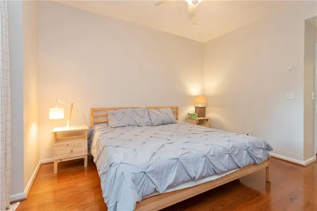 a bedroom with a bed and a night stand