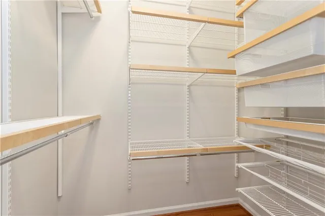 a view of walk in closet with empty racks