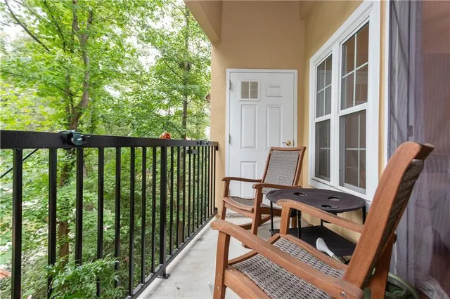 a view of a balcony with chair and wooden floor