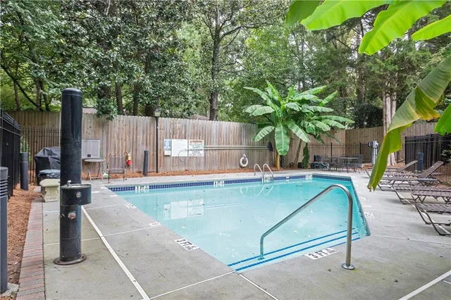 swimming pool view with a outdoor seating