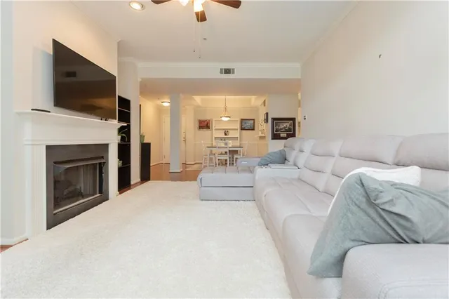 a living room with furniture a fireplace and a flat screen tv