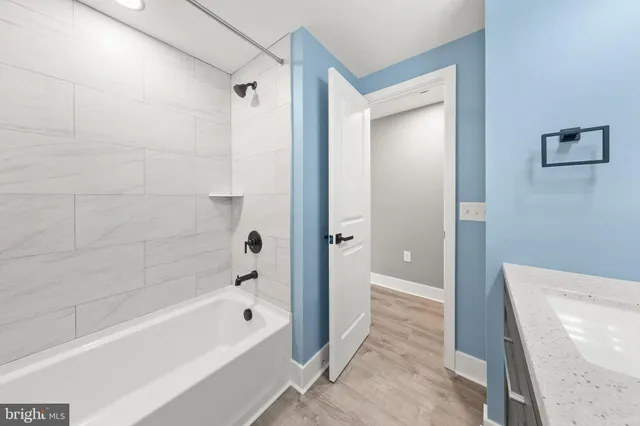 a bathroom with a bathtub and a shower