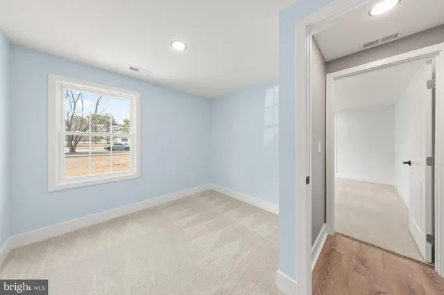 an empty room with windows and closet