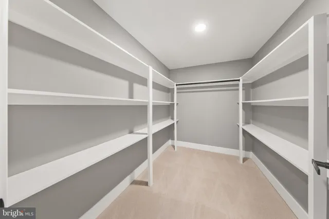 a spacious bathroom with a double vanity sink toilet mirror and double