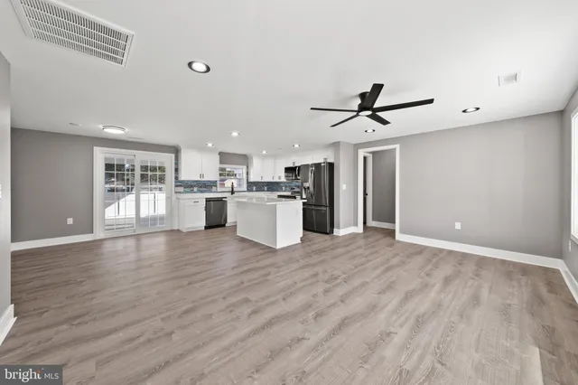 a view of a kitchen with a sink and a refrigerator