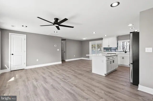 a view of a kitchen with a sink and wooden floor