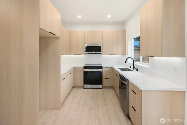 a kitchen with a sink stove and a refrigerator