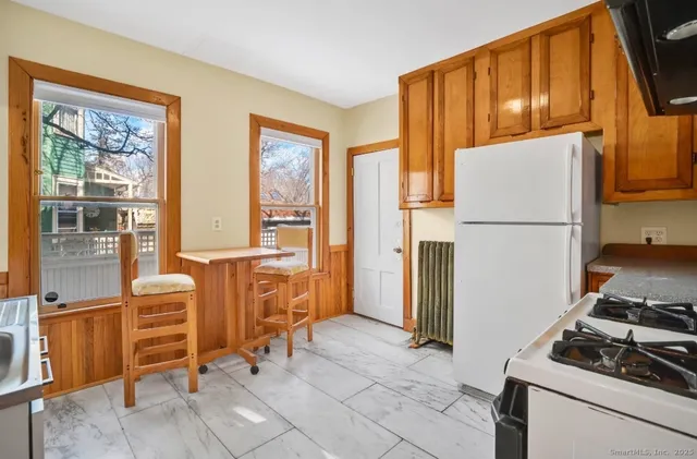 a kitchen with a refrigerator and windows