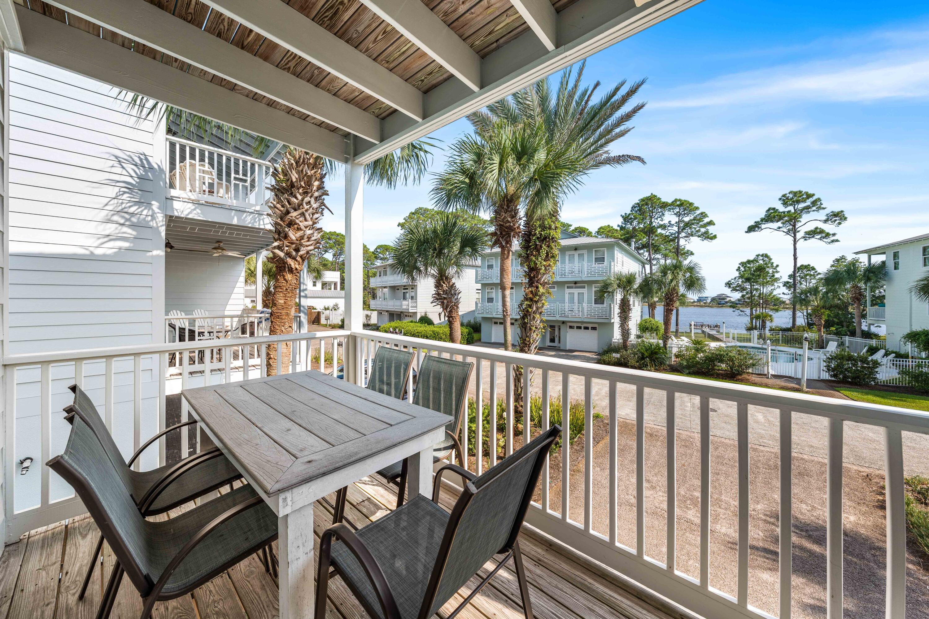 33 Dune Breeze Lane, Unit H2 Santa Rosa Beach, FL 32459 - Photo 23 of 54 a view of a patio with table and chairs and wooden floor
