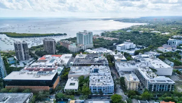 an aerial view of multiple house with yard