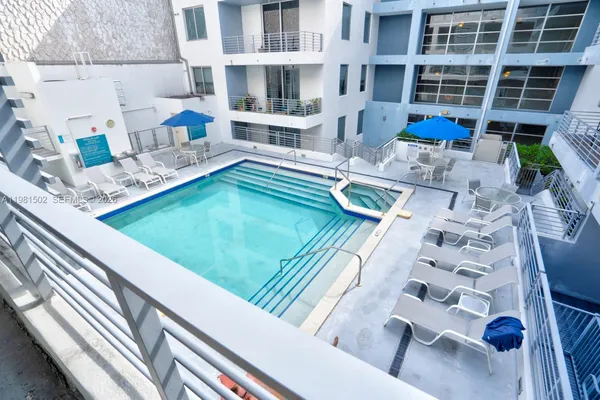 a view of a swimming pool with a lounge chairs