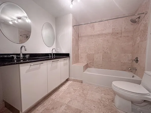 a bathroom with a toilet a sink and a mirror