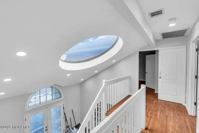 a view of entryway and hall with wooden floor