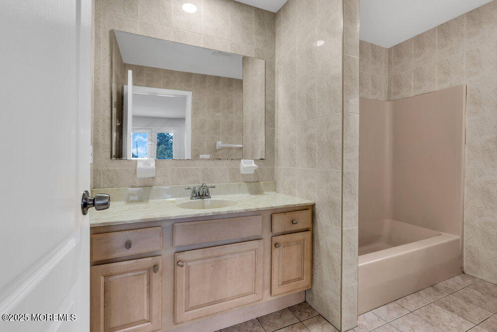 52 16th Street Toms River, NJ 08753 - Photo 22 of 44 a bathroom with a tub sink and mirror