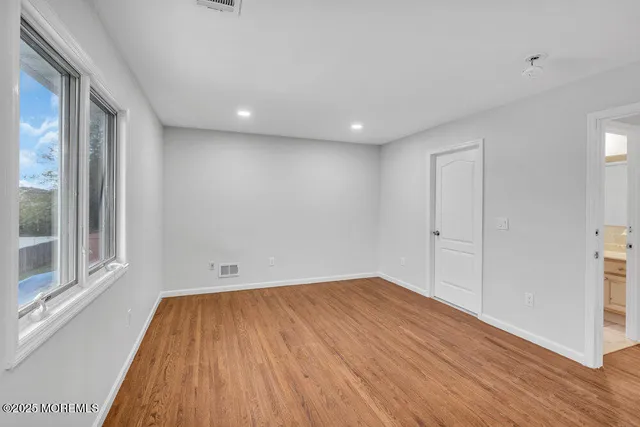 a view of room with window and wooden floor