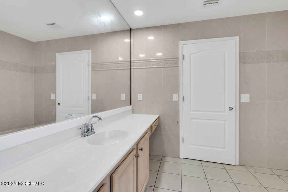 52 16th Street Toms River, NJ 08753 - Photo 35 of 44 a bathroom with a sink vanity and a mirror