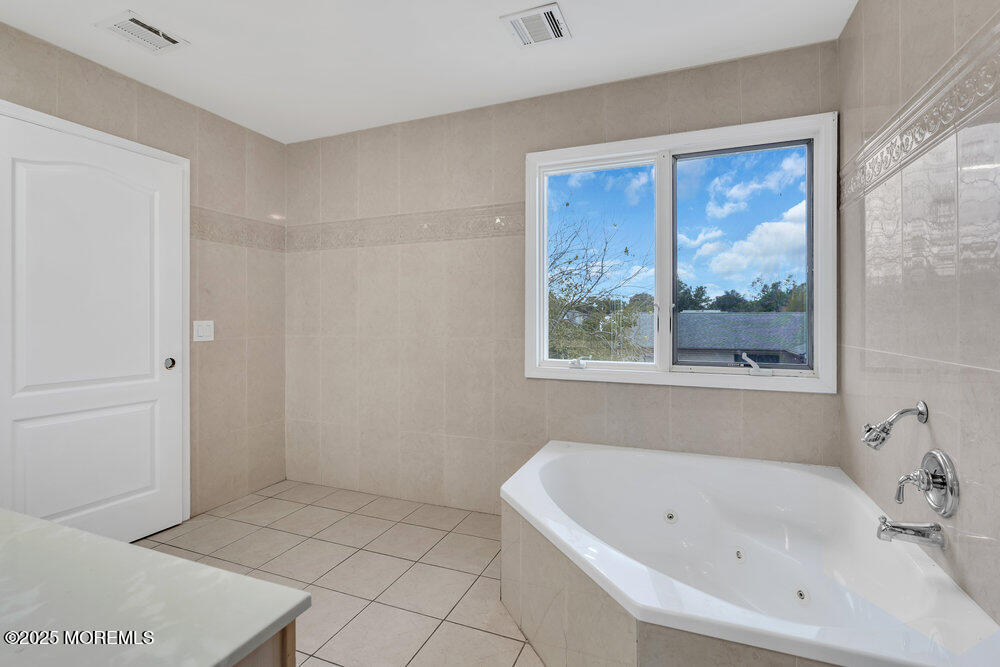 52 16th Street Toms River, NJ 08753 - Photo 36 of 44 a bathroom with a bathtub and large window