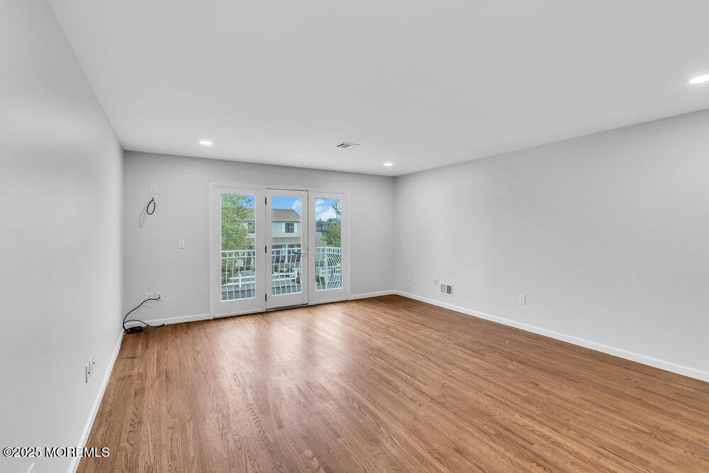 52 16th Street Toms River, NJ 08753 - Photo 41 of 44 a view of an empty room with wooden floor and a window
