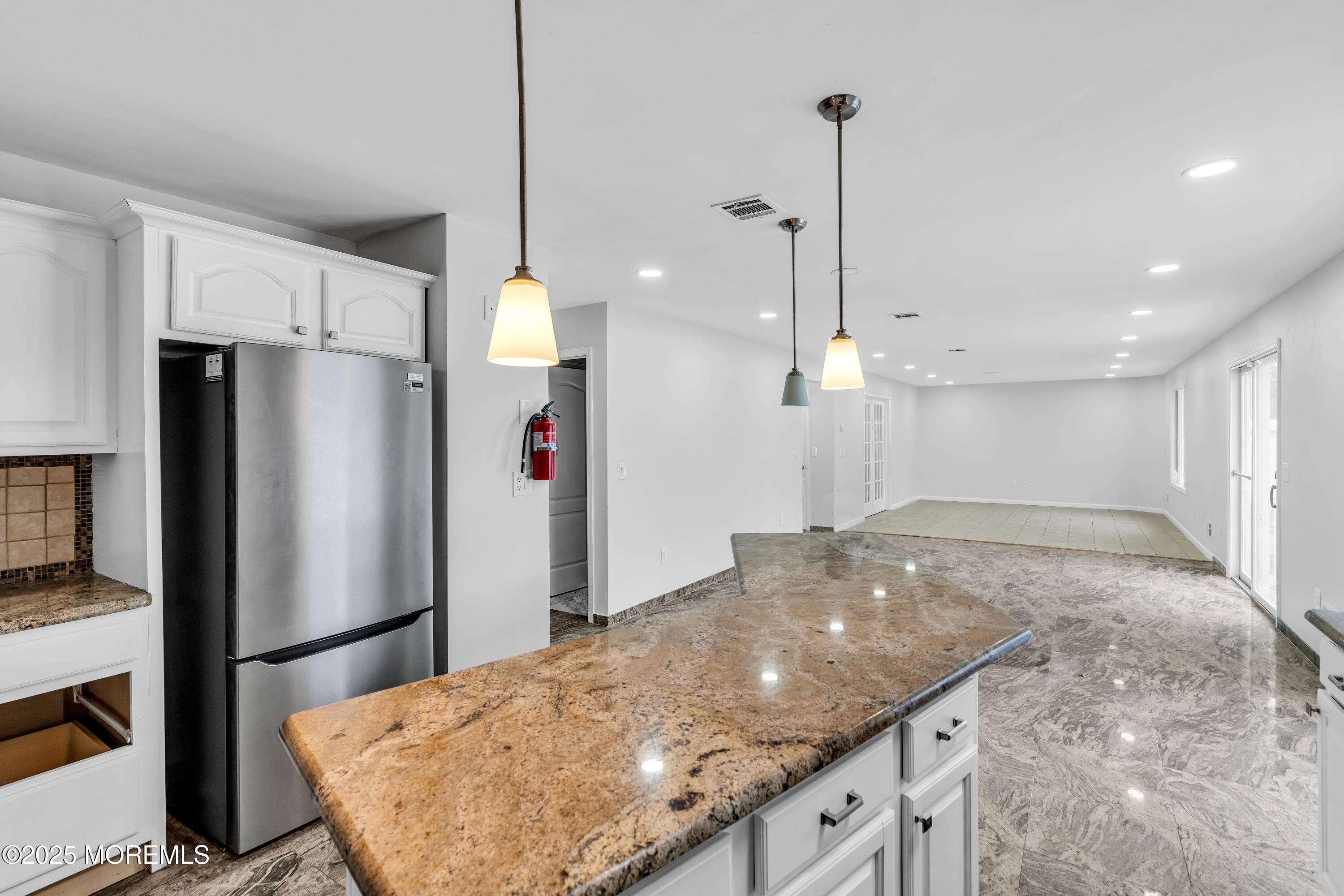 52 16th Street Toms River, NJ 08753 - Photo 5 of 44 a kitchen with kitchen island a counter top space appliances and cabinets