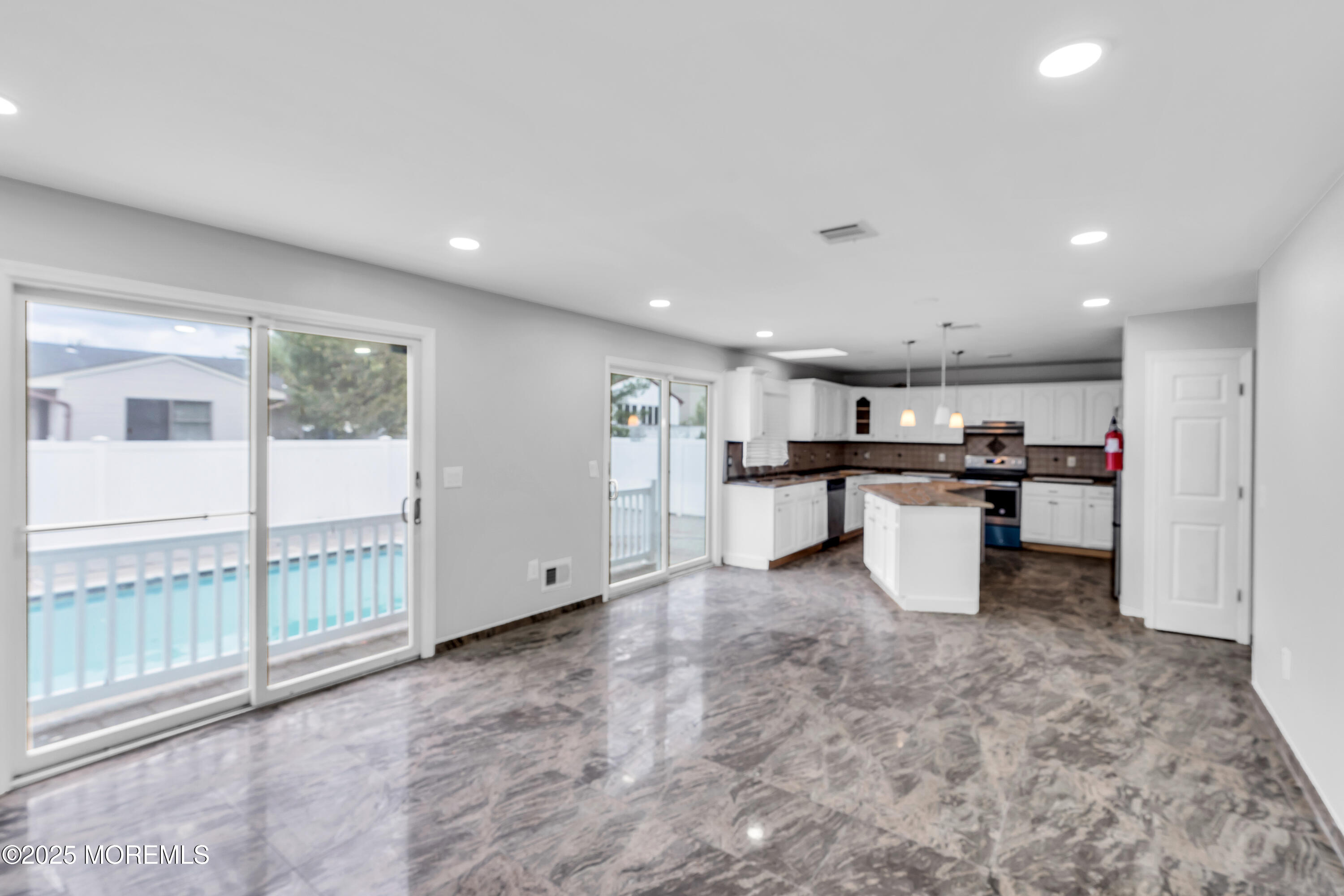 52 16th Street Toms River, NJ 08753 - Photo 9 of 44 a kitchen with stainless steel appliances kitchen island granite countertop a refrigerator and a sink