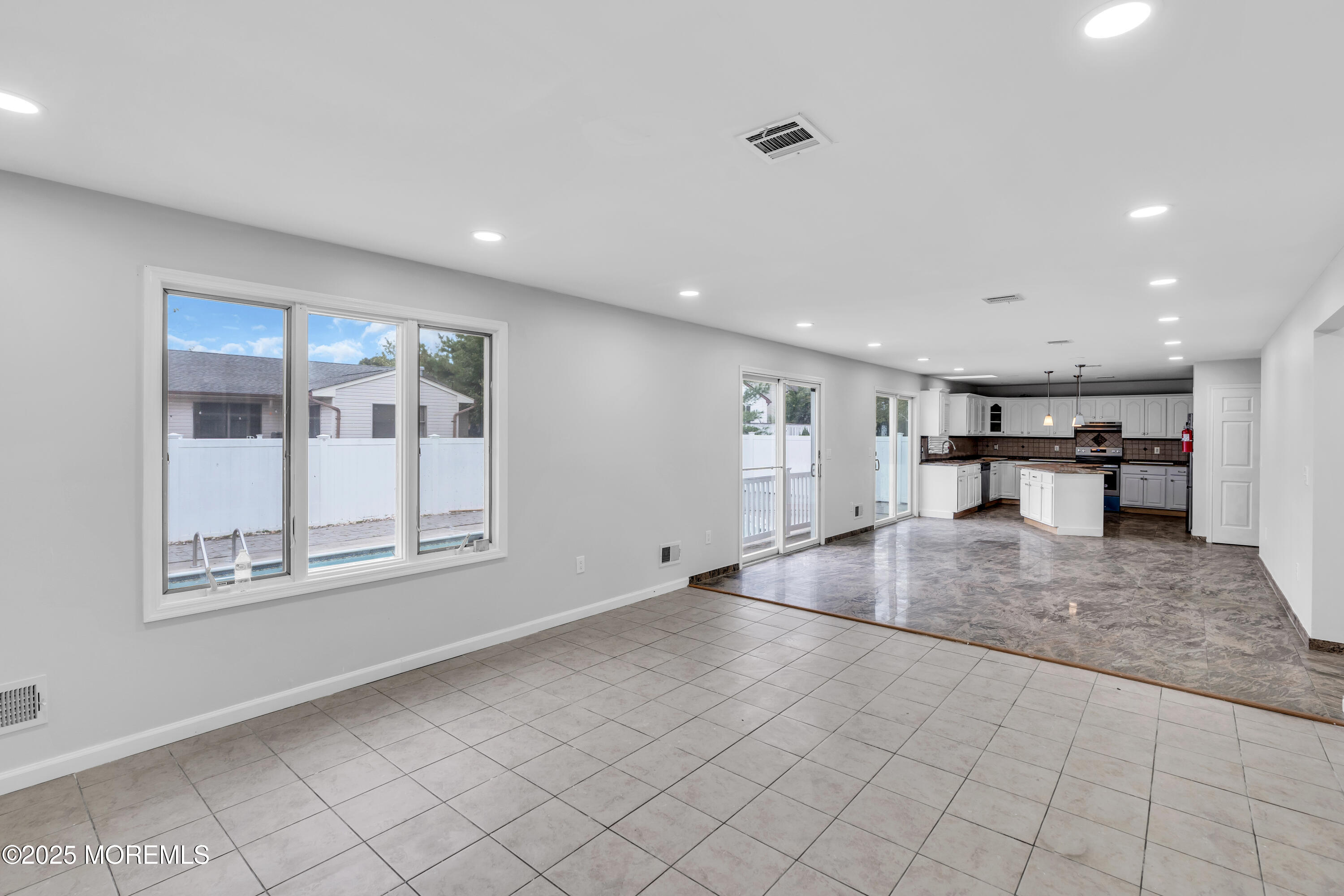 52 16th Street Toms River, NJ 08753 - Photo 10 of 44 an empty room with wooden floor and a large window