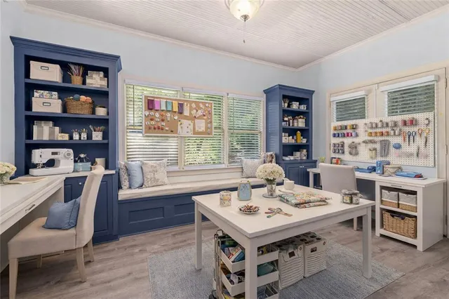 a view of a workspace with furniture and a bookshelf