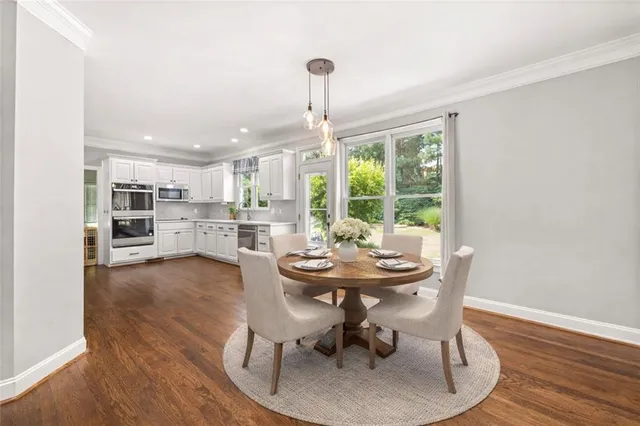 a dining room with furniture and window