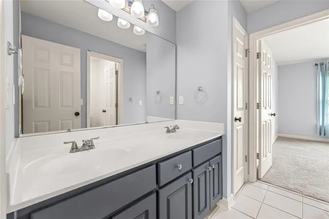a bathroom with a sink double vanity granite tub and shower