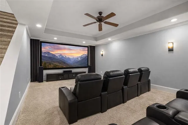 a projector room with furniture and a flat screen tv