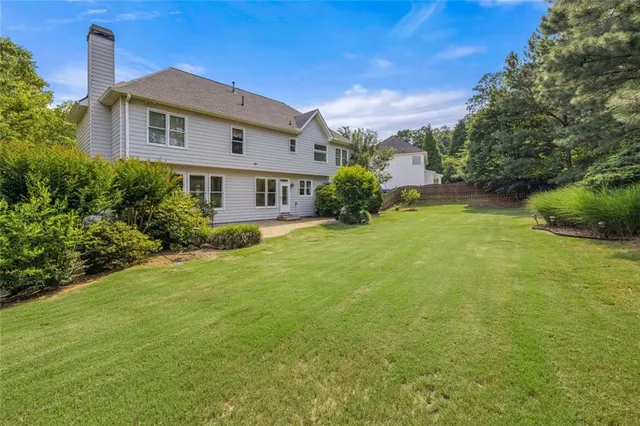 a front view of house with yard and trees